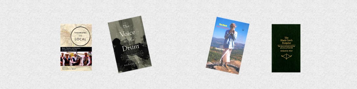 Four of Richard K. Wolf's book covers standing in a row on a pale textured ground.